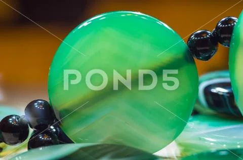 Large polished beads of beautiful translucent green agate gemstone, macro Stock Photos