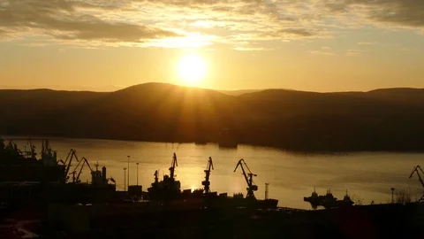 A large port and a bay in the background of the setting sun. Stock Footage 83159609