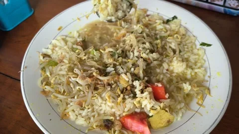 A large portion of chicken soto mixed with rice Stock Footage 319069631