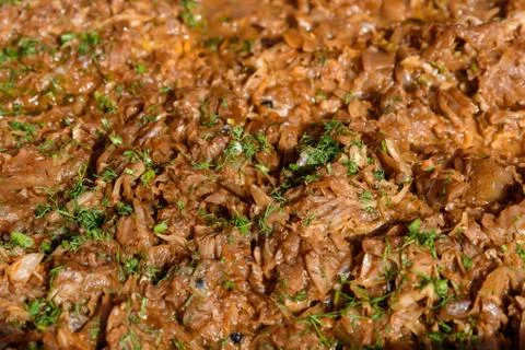 Large portion of cooked cut cabbage with green dill leaves at a food market Stock Photos