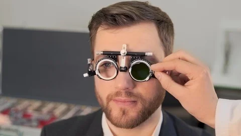 A large portrait of a pretty man picks up lenses for new glasses Video stock 126494395