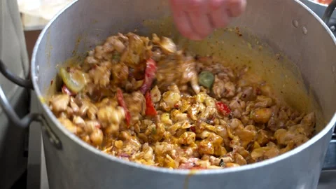 Large Pot of Chicken and Vegetables Being Stirred in Busy Kitchen Stock-Footage 321367096