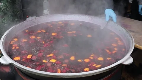 A large pot of delicious fruit stew on the stove, steam rising and creating a Stock Footage 294823537