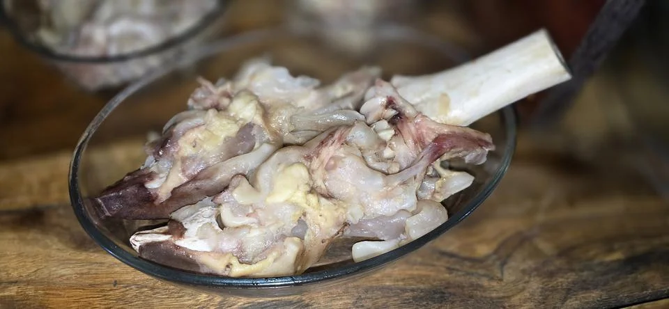 A large pot filled with cooked cow's feet or cow knuckle, arranged in rows .. Stock Photos