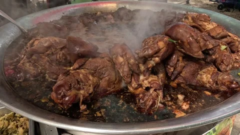 Large pot of steaming braised pork legs simmering in savory dark sauce, a t.. 스톡 동영상 334318382