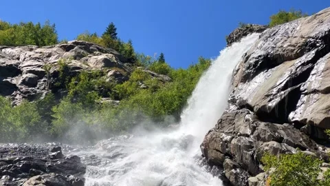 A large, powerful, beautiful waterfall in the mountains. Caucasus, Dombai.  Stock Footage 287538550