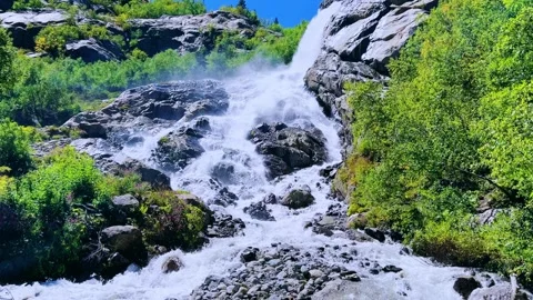 A large, powerful, beautiful waterfall in the mountains.  Stock Footage 301866985