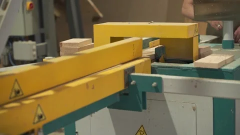 Large powerful heavy woodworking machine saws a wooden board into pieces Stock Footage 163823007