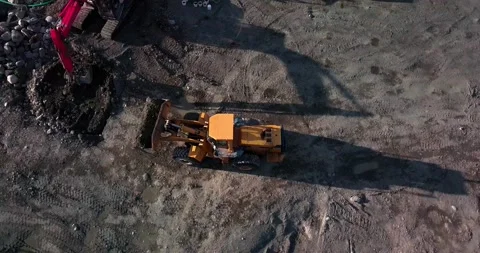 Large powerful yellow mining wheel operating loader lift carrying brown Stock Footage 139689444