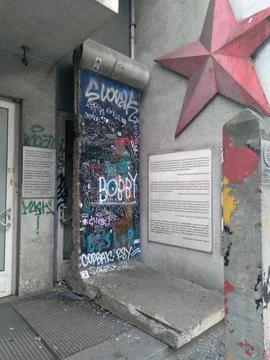 A large preserved section of the Berlin Wall covered with graffiti art Фото