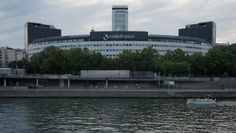A large public broadcasting headquarters building stands by the Seine river Stock Footage 336721958