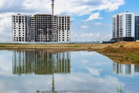 A large puddle after rain at the construction site of a large residential Stock-Fotos