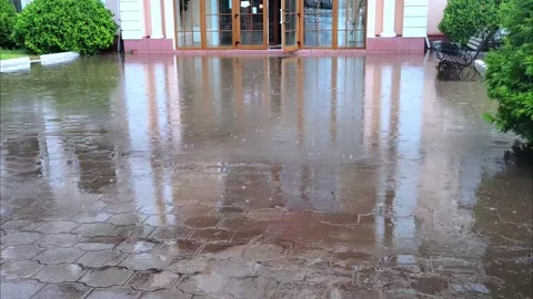 Large puddle in front of the house. Large puddle during heavy rain in the city. Stock Footage 289513481