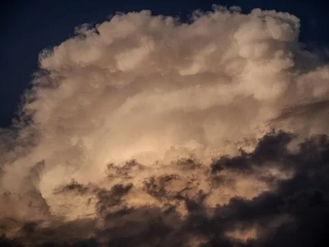 A large puffy cloud illuminated by the sunset Stock Photos