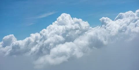 Large, puffy cumulus clouds. Blue sky with scattered white cumulus clouds. Cl Stock Photos