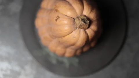 A large pumpkin on a black plate, moving in a circle. Stock Footage 223319256