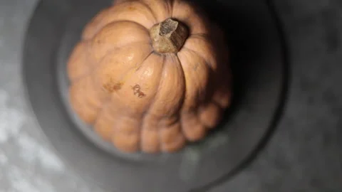 A large pumpkin is spinning on a plate, then a plate with ready-made pumpkin Stock Footage 221532880