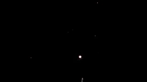 Large purple firework burst illuminates the dark night sky Video stock 329676128