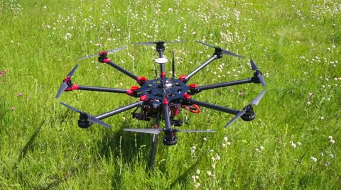 Large quadrocopter on the green lawn ready for takeoff Stock Footage 51682182