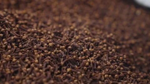 A large quantity of brown cloves are piled on a surface for display. Video stock 328026814