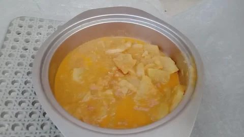 Large quantity of curry filled in deep metal vessel Stockbeeldmateriaal 347991190