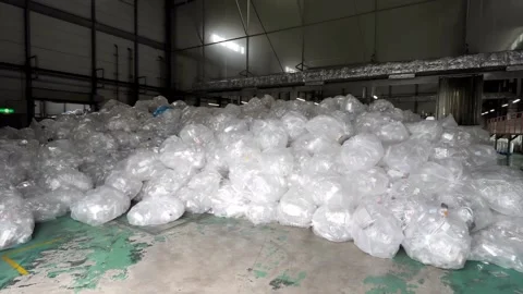 A large quantity of used plastic boxes, wrapped in plastic bags, is stored Stock Footage 288185318
