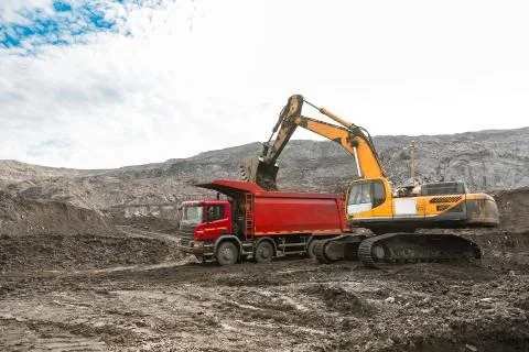 Large quarry dump truck. Loading the rock in dumper. Loading coal into body Stock Photos