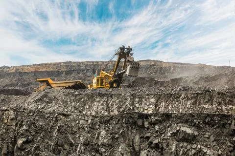 Large quarry dump truck. Loading the rock in dumper. Loading coal into body Stock Photos