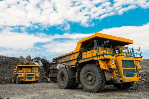 Large quarry dump truck. Loading the rock in dumper. Loading coal into body Stock Photos
