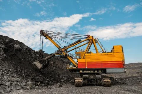 Large quarry dump truck. Loading the rock in dumper. Loading coal into body Stock Photos