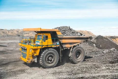 Large quarry dump truck. Loading the rock in dumper. Loading coal into body Stock Photos