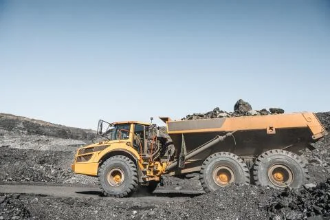 Large quarry dump truck. Loading the rock in dumper. Loading coal into body Stock Photos