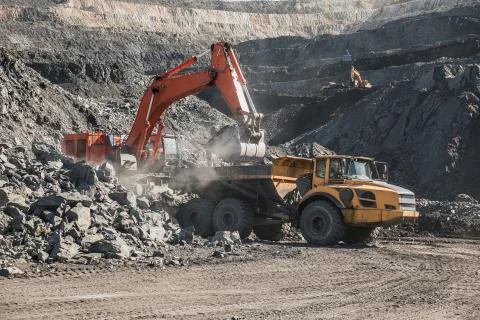 Large quarry dump truck. Loading the rock in dumper. Loading coal into body 写真素材