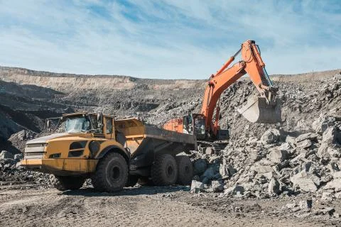 Large quarry dump truck. Loading the rock in dumper. Loading coal into body Stock Photos