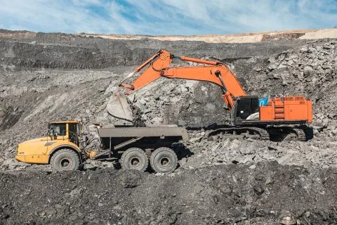 Large quarry dump truck. Loading the rock in dumper. Loading coal into body Stock Photos