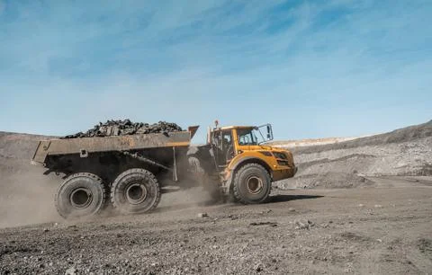 Large quarry dump truck. Loading the rock in dumper. Loading coal into body 写真素材