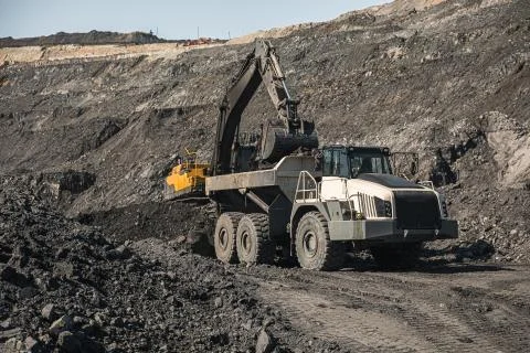 Large quarry dump truck. Loading the rock in dumper. Loading coal into body 写真素材