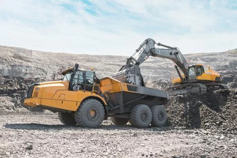 Large quarry dump truck. Loading the rock in dumper. Loading coal into body 写真素材