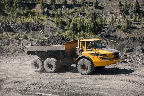 Large quarry dump truck. Loading the rock in dumper. Loading coal into body 写真素材