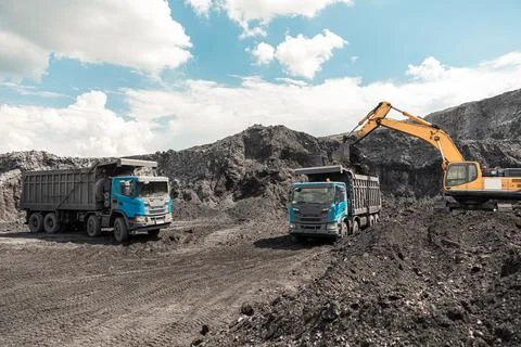 Large quarry dump truck. Loading the rock in dumper. Loading coal into body Stock Photos