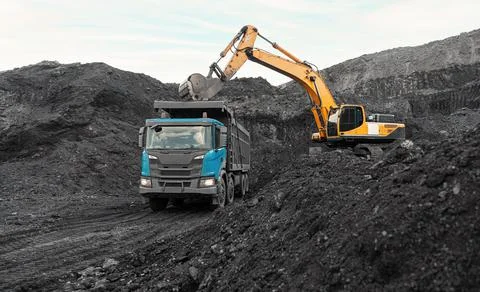 Large quarry dump truck. Loading the rock in dumper. Loading coal into body Stock Photos