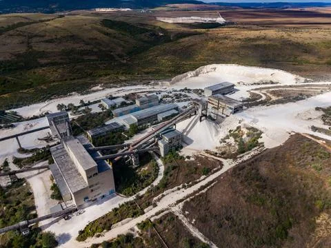 Large quarry site with processing facilities and surrounding landscape in t.. Stock Photos