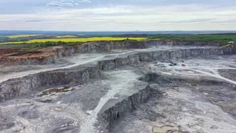 Large quarry site showing mining activity with large machinery and machinery Stock Footage 342470137