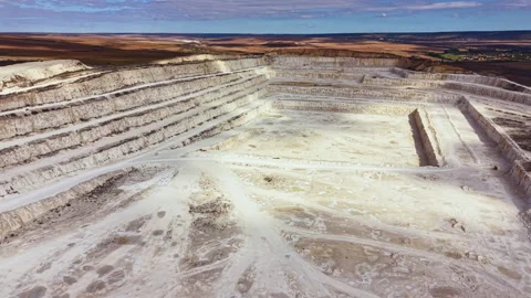 Large quarry site showing multiple levels and pathways with equipment scattered Stock Footage 345455614