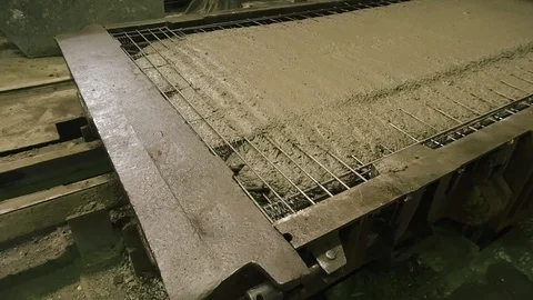 A large radio-controlled machine fills the concrete in form. Workers in the Stock Footage