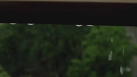 Large rain droplets sliding down the window, summer rain viewed from inside the Stock Footage 281577131