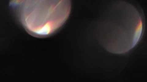 Large rainbow bokeh light leak on black background 스톡 동영상 318916946