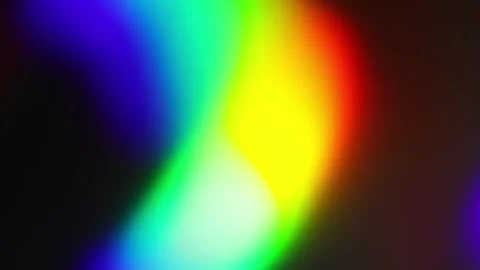 Large rainbow bokeh shape moving and changing form on a black abstract back.. Stock Footage 340034559