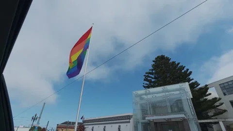 Large rainbow pride flag waves on a flagpole at Harvey Milk Plaza in the Castro Stock Footage 345599618