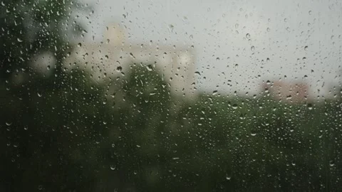Large raindrops on the window during the rain against the background of the city Stock Footage 337073181